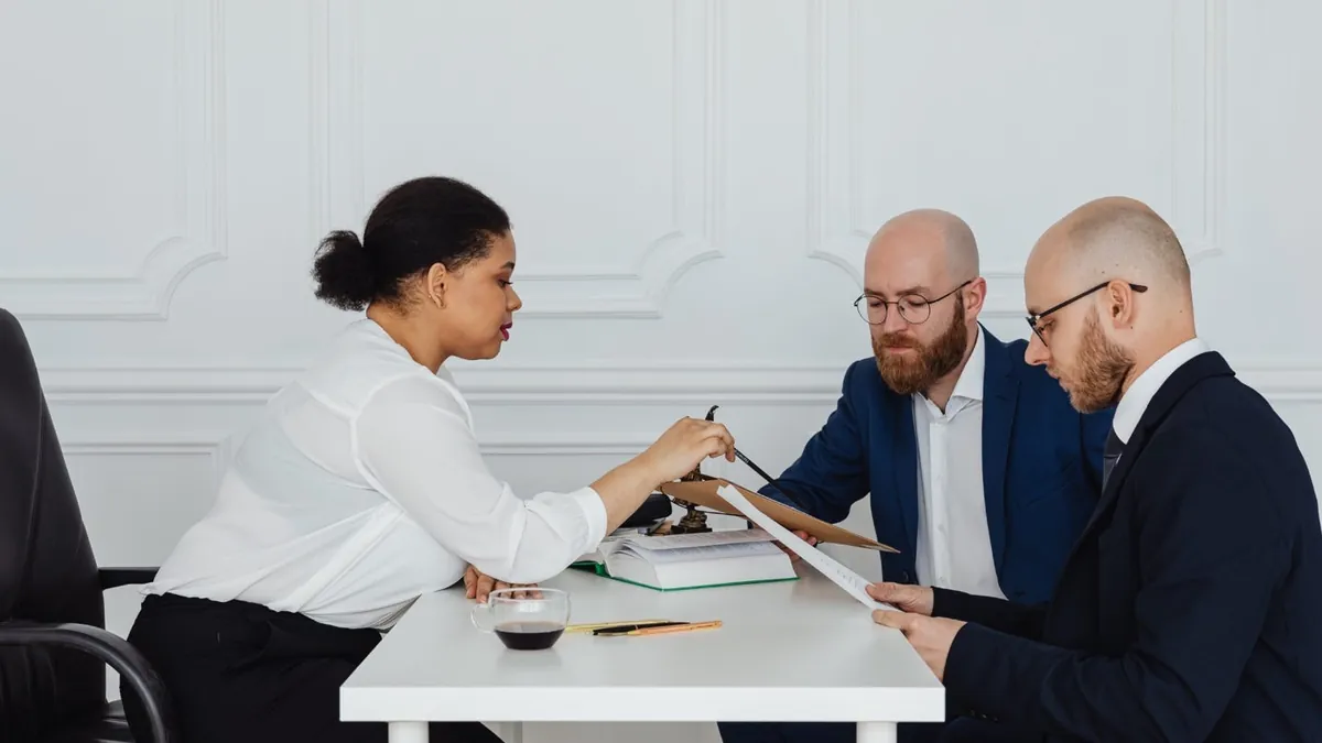 A group of people sitting at a table

AI-generated content may be incorrect.