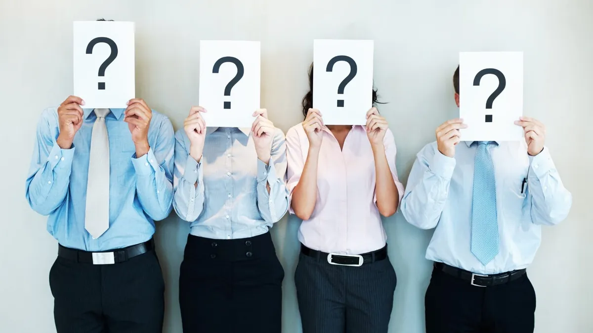 A group of people holding up paper with question marks

AI-generated content may be incorrect.